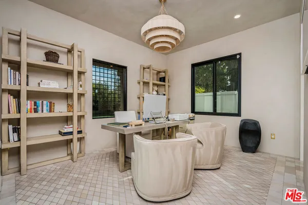 a living room with furniture and a book shelf