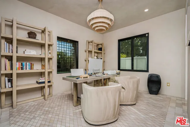 a living room with furniture and a book shelf