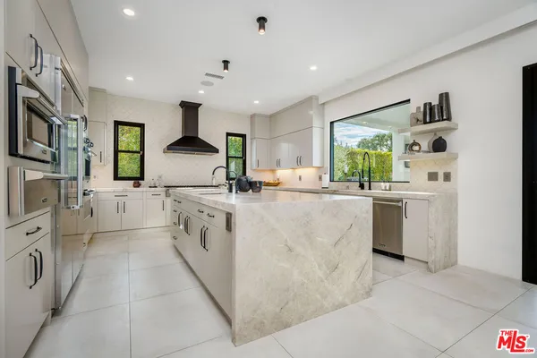 a kitchen with cabinets and window