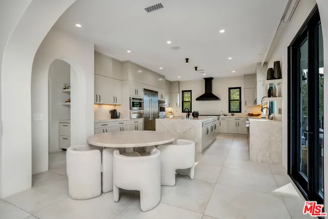 a living room with furniture a dining table and chairs