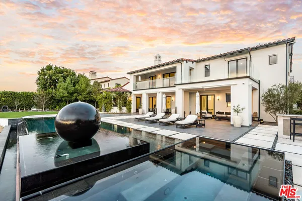 a view of a house with pool and chairs