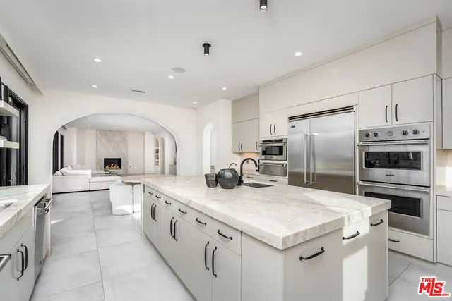 a kitchen with a sink stove and refrigerator