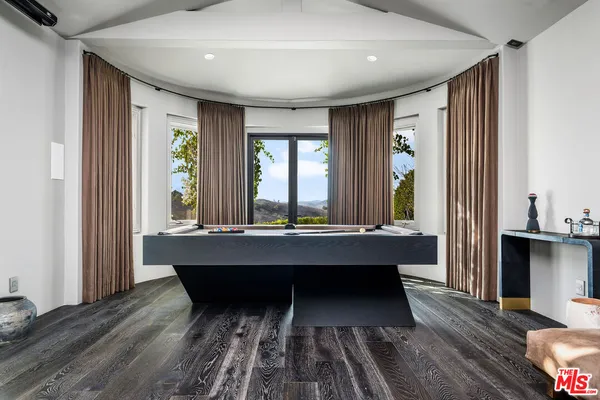 a room with wooden floor table and chair