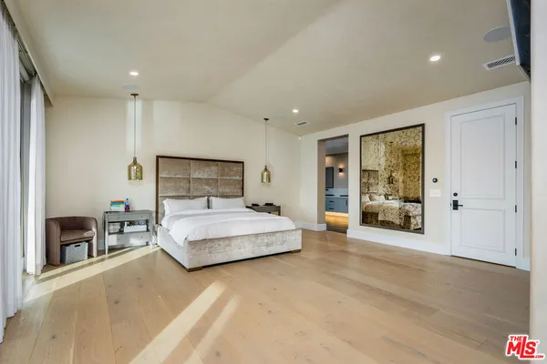 a spacious bedroom with a large bed and a couch