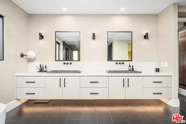 a bathroom with a double vanity sink and mirror