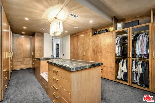 a kitchen with counter top space and stainless steel appliances
