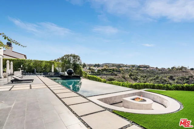 a view of swimming pool with seating space