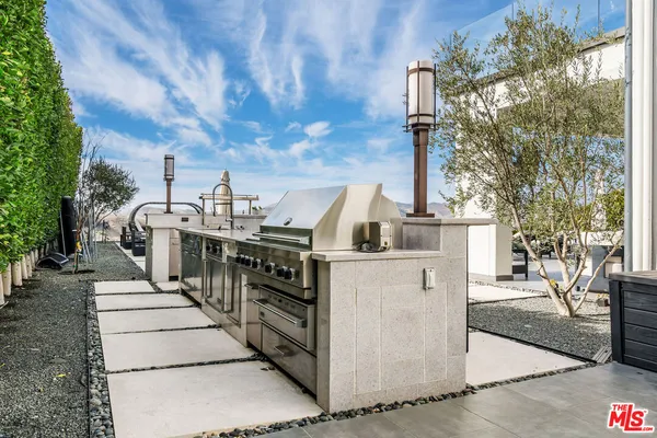 a view of a patio with table and chairs with wooden floor and fence