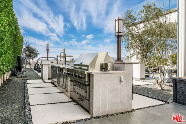 a view of a patio with table and chairs with wooden floor and fence