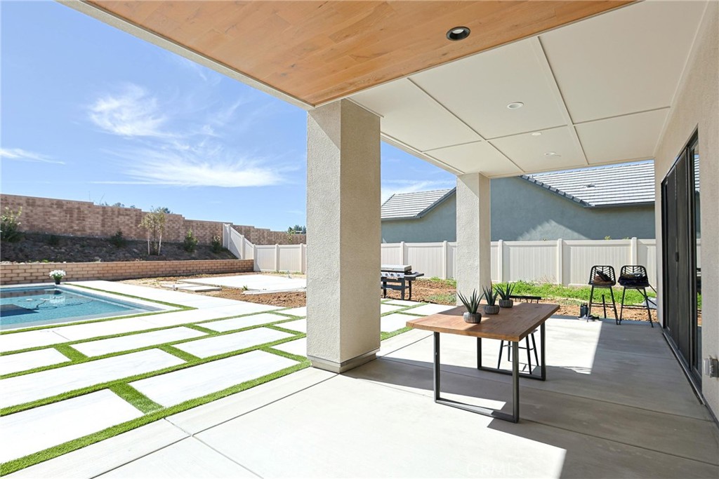 32213 Daybrook Terrace Temecula, CA 92591 - Photo 25 of 75 a view of a patio with table and chairs with wooden floor and fence
