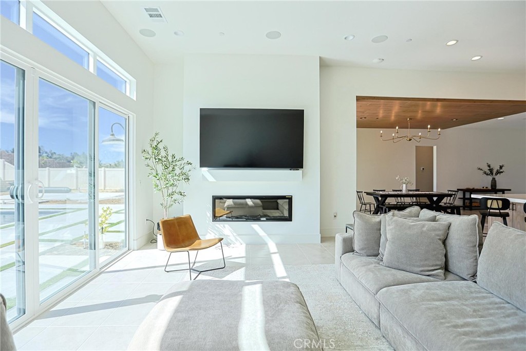 32213 Daybrook Terrace Temecula, CA 92591 - Photo 32 of 75 a living room with furniture a fireplace and a flat screen tv