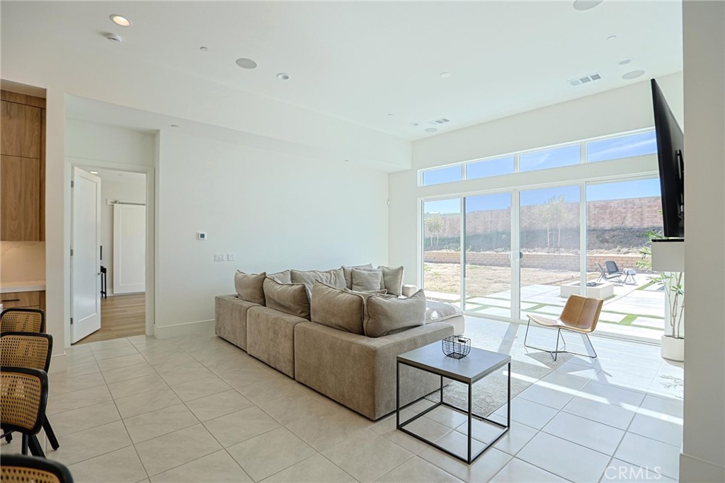 32213 Daybrook Terrace Temecula, CA 92591 - Photo 34 of 75 a living room with furniture and a floor to ceiling window
