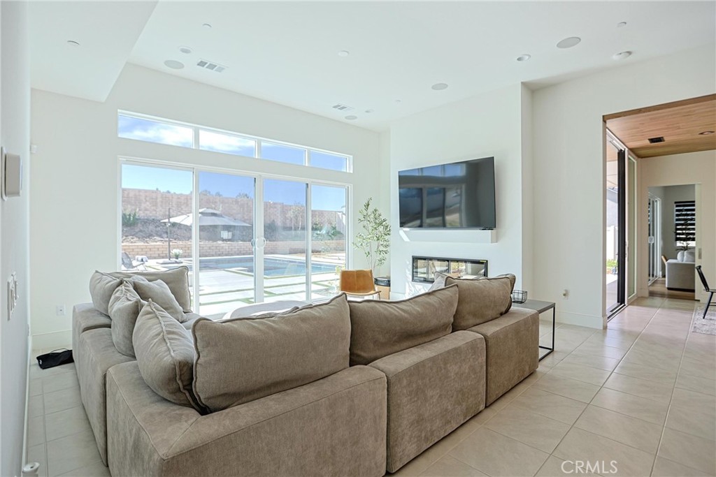 32213 Daybrook Terrace Temecula, CA 92591 - Photo 36 of 75 a living room with furniture a large window and a flat screen tv