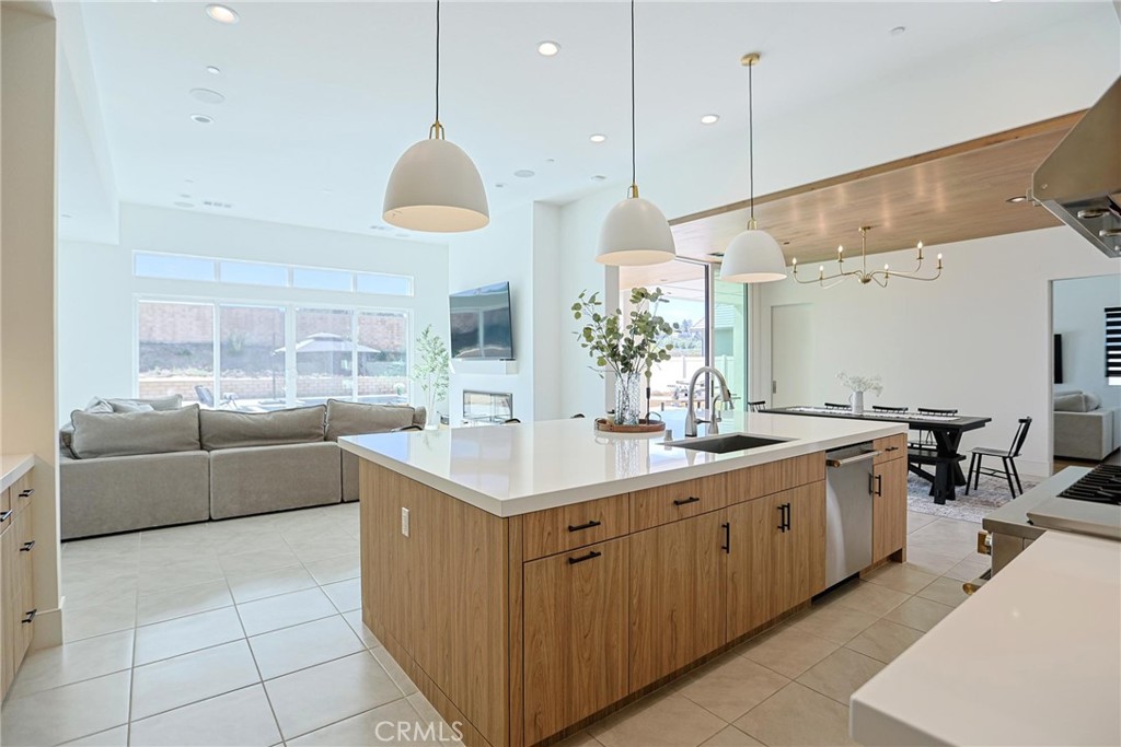 32213 Daybrook Terrace Temecula, CA 92591 - Photo 39 of 75 a large kitchen with kitchen island a large counter a sink a stove and a window