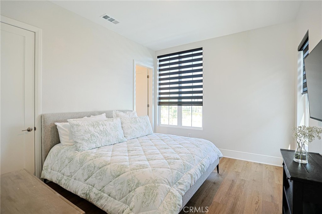 32213 Daybrook Terrace Temecula, CA 92591 - Photo 49 of 75 a large bed sitting in a bedroom next to a window and a wooden floor