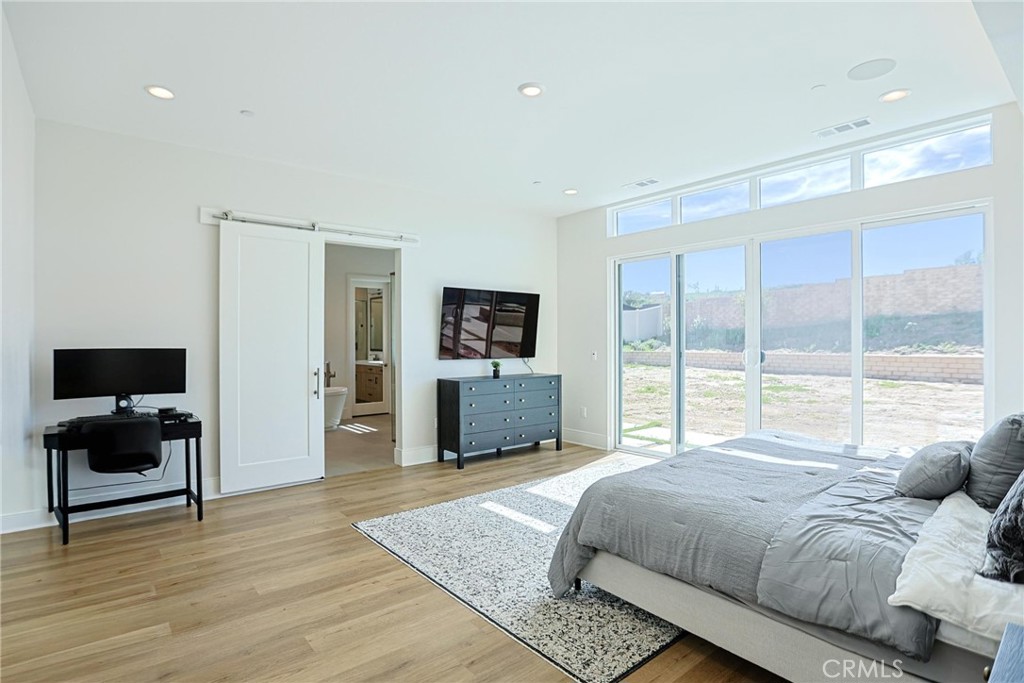 32213 Daybrook Terrace Temecula, CA 92591 - Photo 54 of 75 a bedroom with a bed and large windows