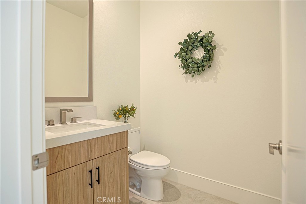 32213 Daybrook Terrace Temecula, CA 92591 - Photo 74 of 75 a bathroom with a toilet a sink and mirror