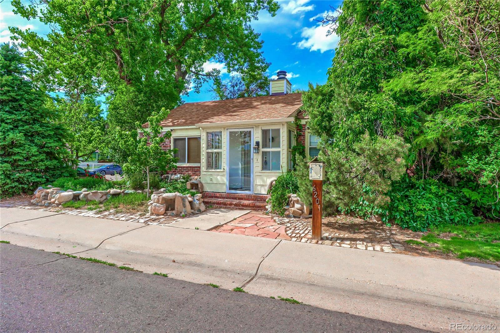 6201 East Tennessee Avenue Denver, CO 80224 - Photo 1 of 25 a view of a house with a tree and plants