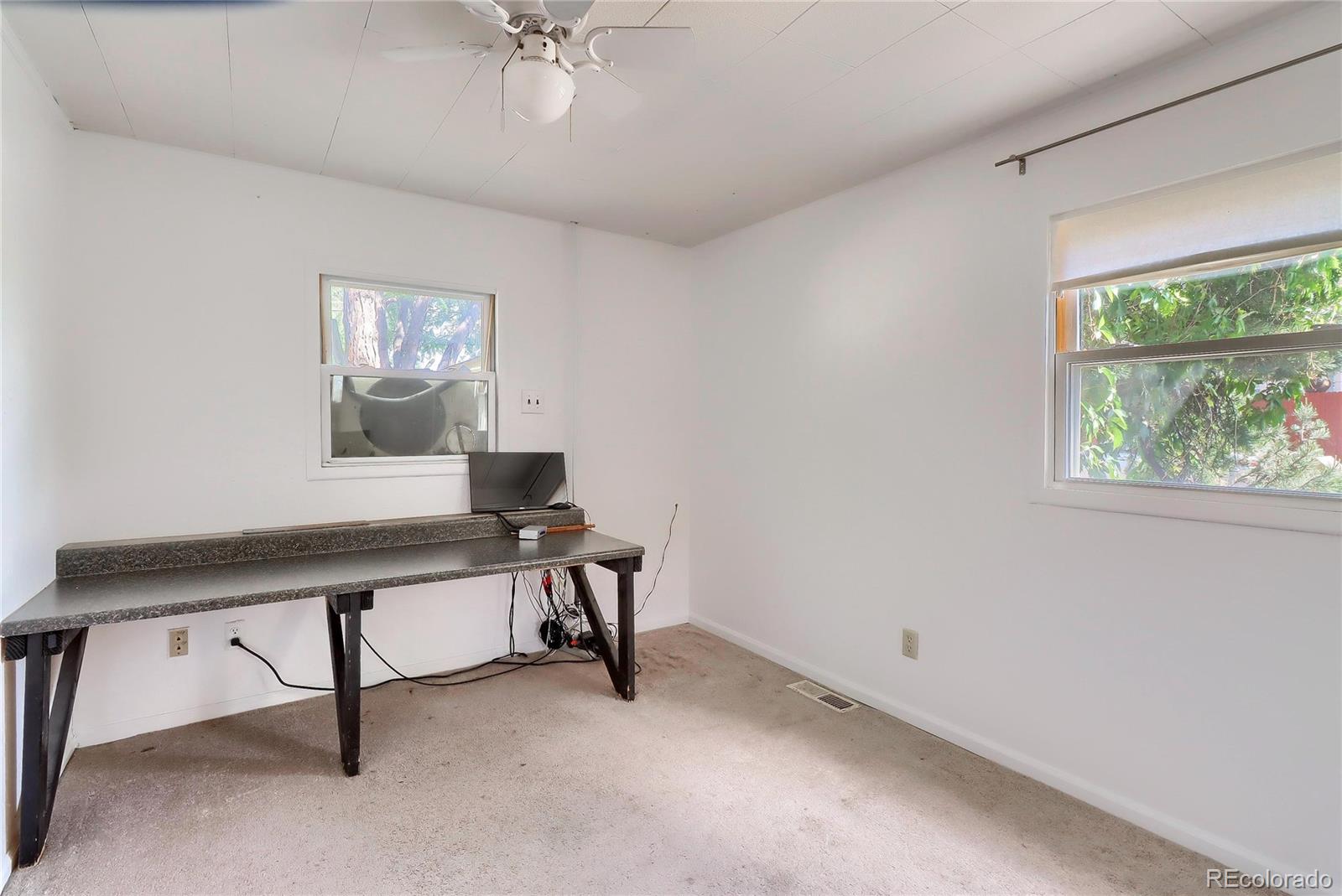 6201 East Tennessee Avenue Denver, CO 80224 - Photo 11 of 25 a view of a workspace with furniture and a window