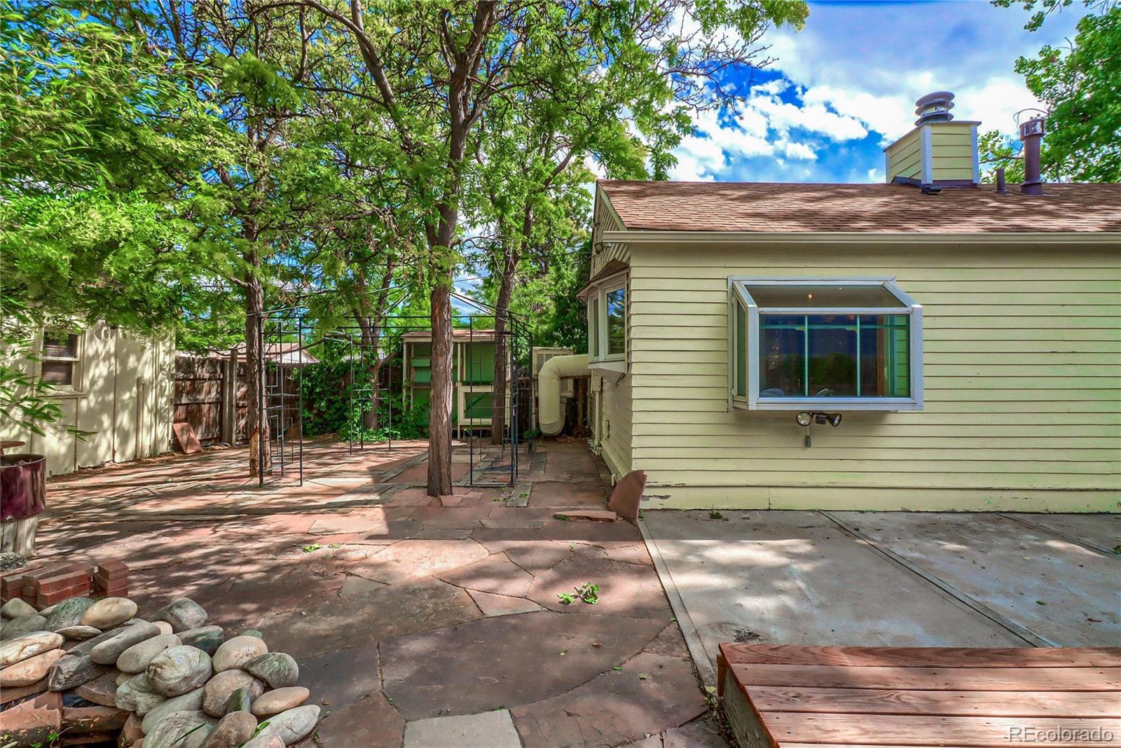 6201 East Tennessee Avenue Denver, CO 80224 - Photo 17 of 25 a view of a backyard with plants and large tree