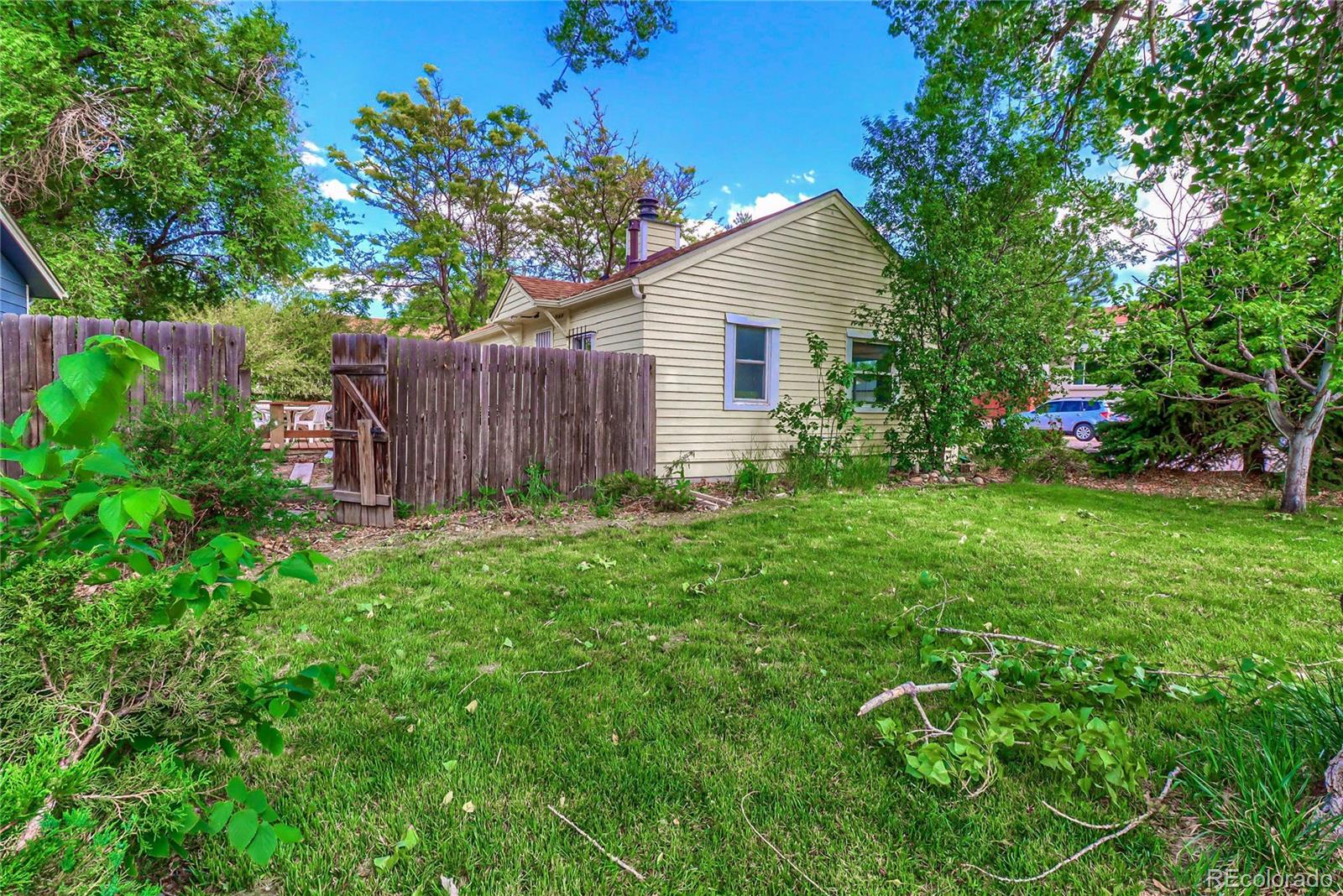 6201 East Tennessee Avenue Denver, CO 80224 - Photo 20 of 25 a view of a backyard with potted plants and large tree