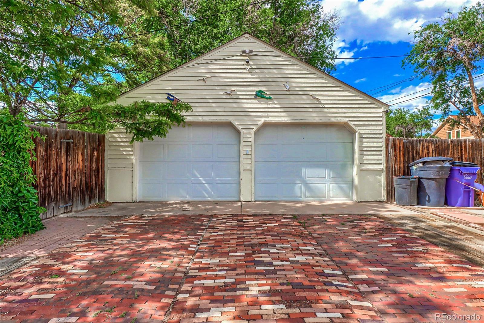 6201 East Tennessee Avenue Denver, CO 80224 - Photo 22 of 25 a front view of a house with a yard and garage