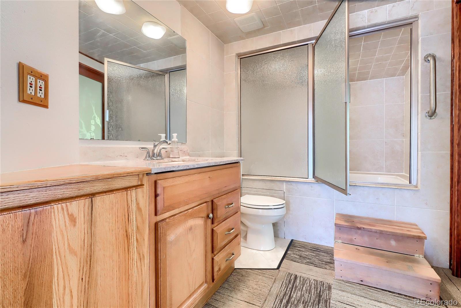 6201 East Tennessee Avenue Denver, CO 80224 - Photo 10 of 25 a bathroom with a sink a toilet and shower