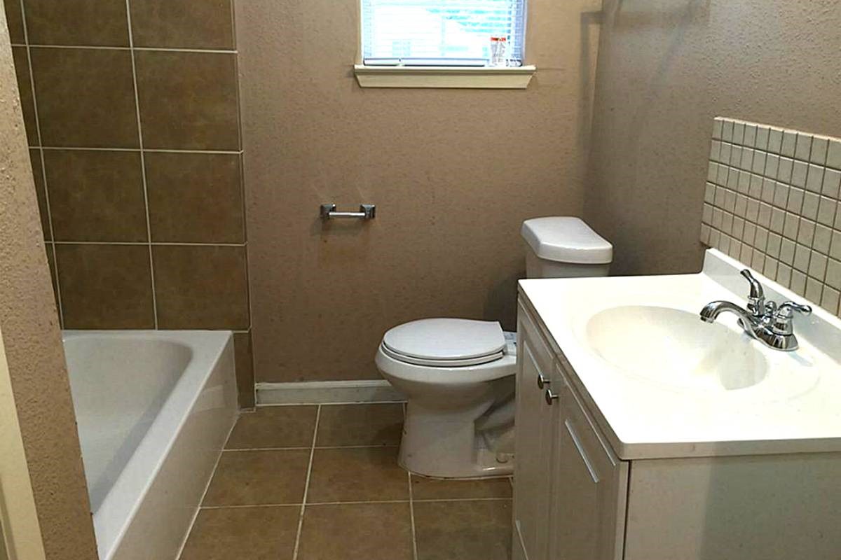 5103 Yellowstone Boulevard Houston, TX 77021 - Photo 7 of 10 a bathroom with a sink toilet and shower
