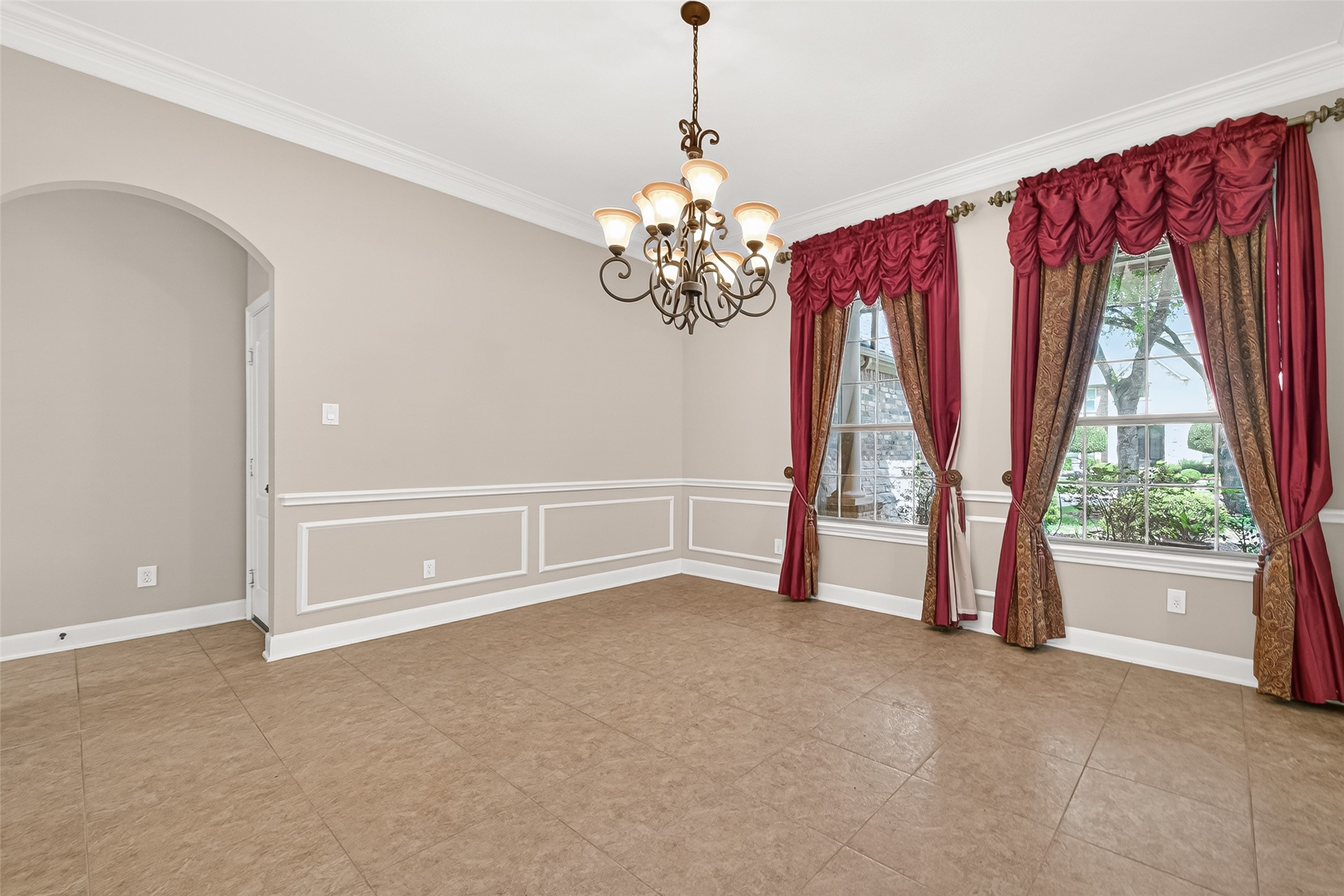 2310 Spring Lake Park Lane Spring, TX 77386 - Photo 6 of 47 a view of a livingroom with a chandelier curtains and large windows