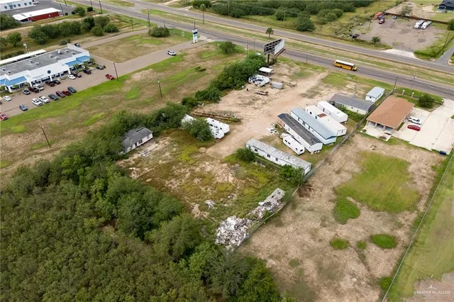 an aerial view of a house with a yard basket ball court and outdoor seating