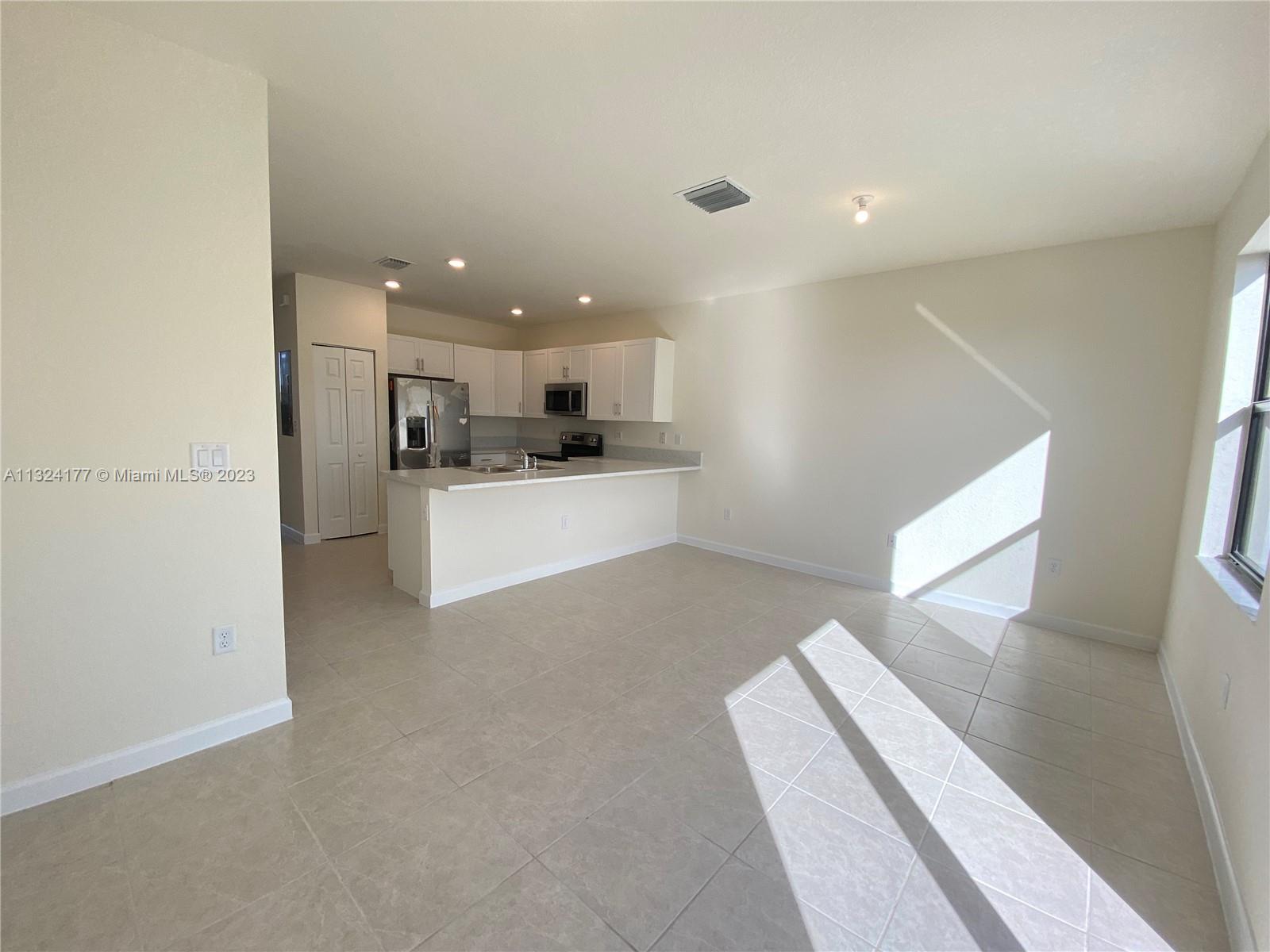 Hialeah Hialeah, FL 33018 - Photo 2 of 30 a view of a kitchen with a stove wooden cabinets and a refrigerator