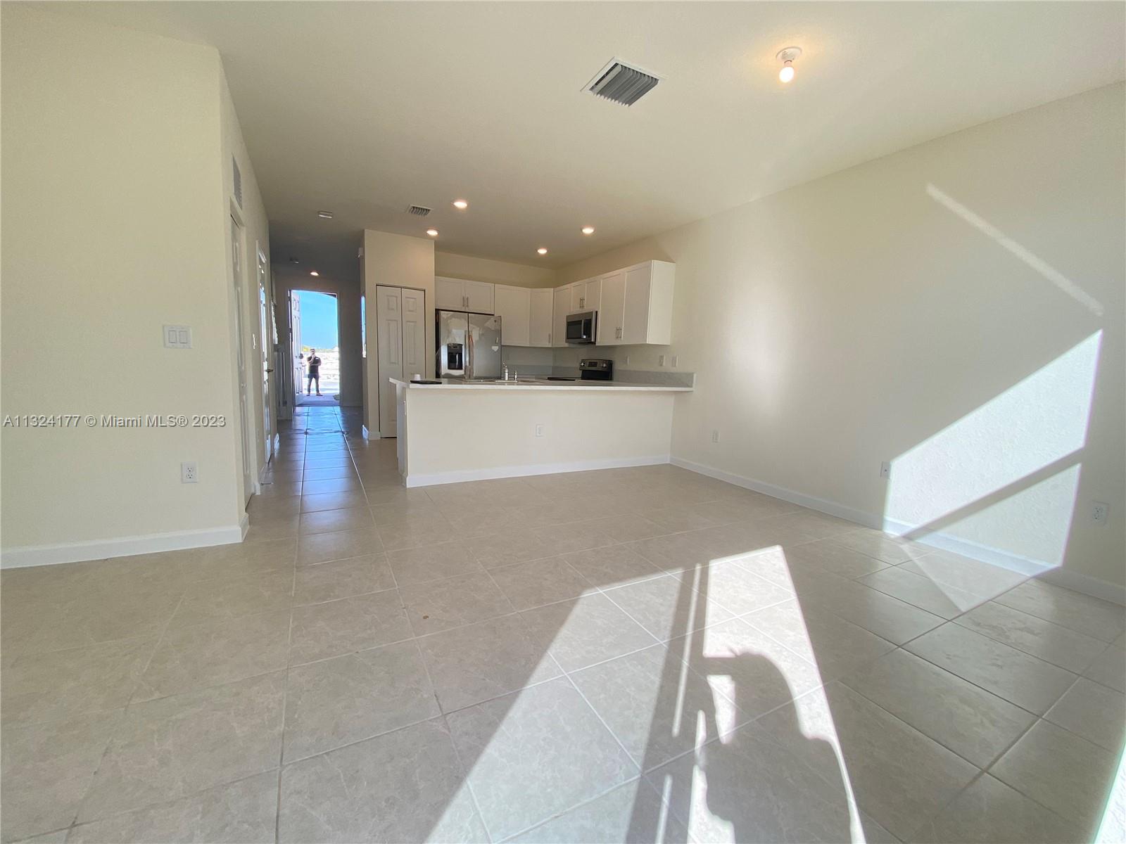 Hialeah Hialeah, FL 33018 - Photo 6 of 30 a view of a kitchen with kitchen island wooden floor center island and stainless steel appliances