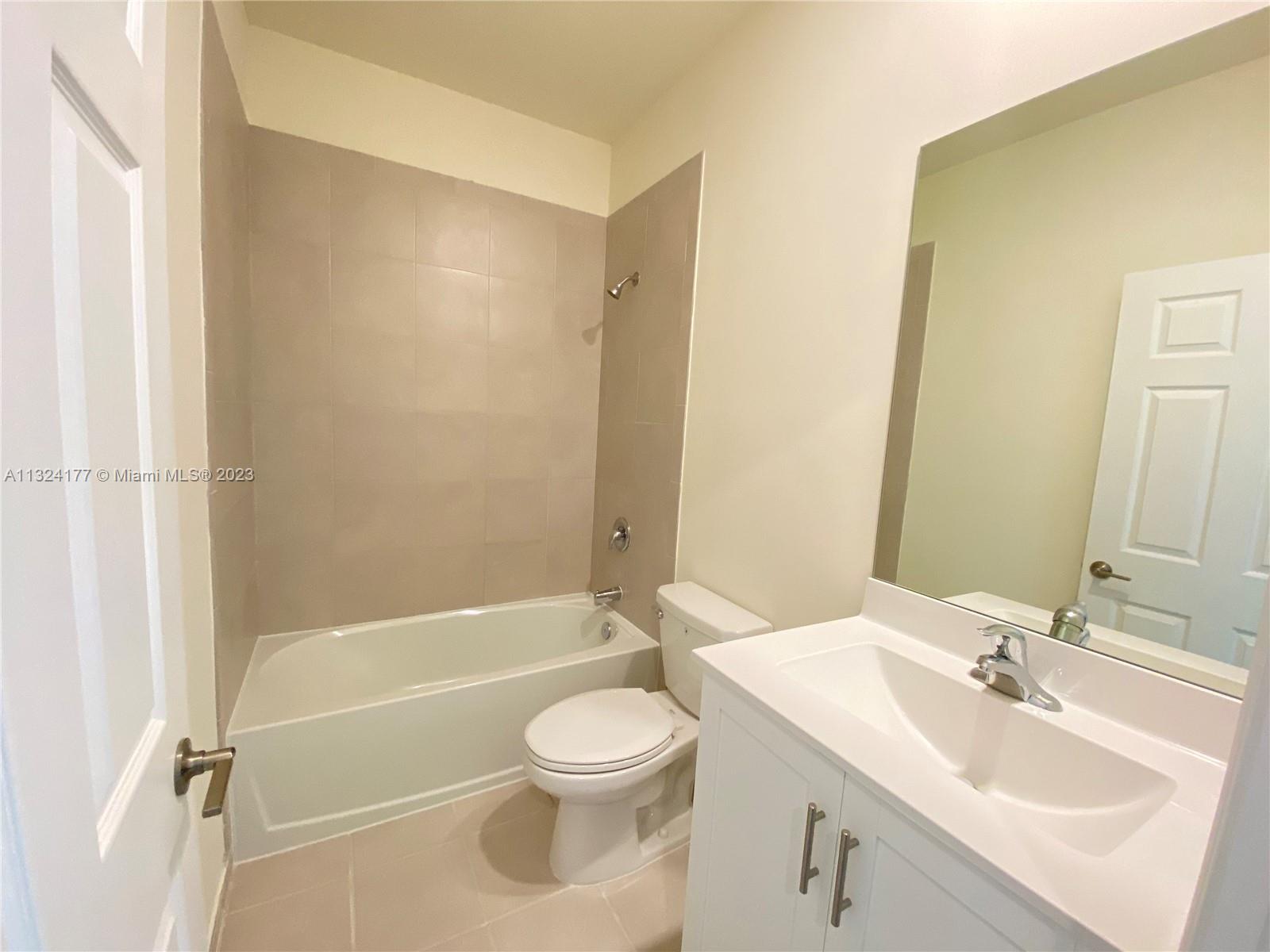 Hialeah Hialeah, FL 33018 - Photo 10 of 30 a bathroom with a sink a toilet and a bathtub