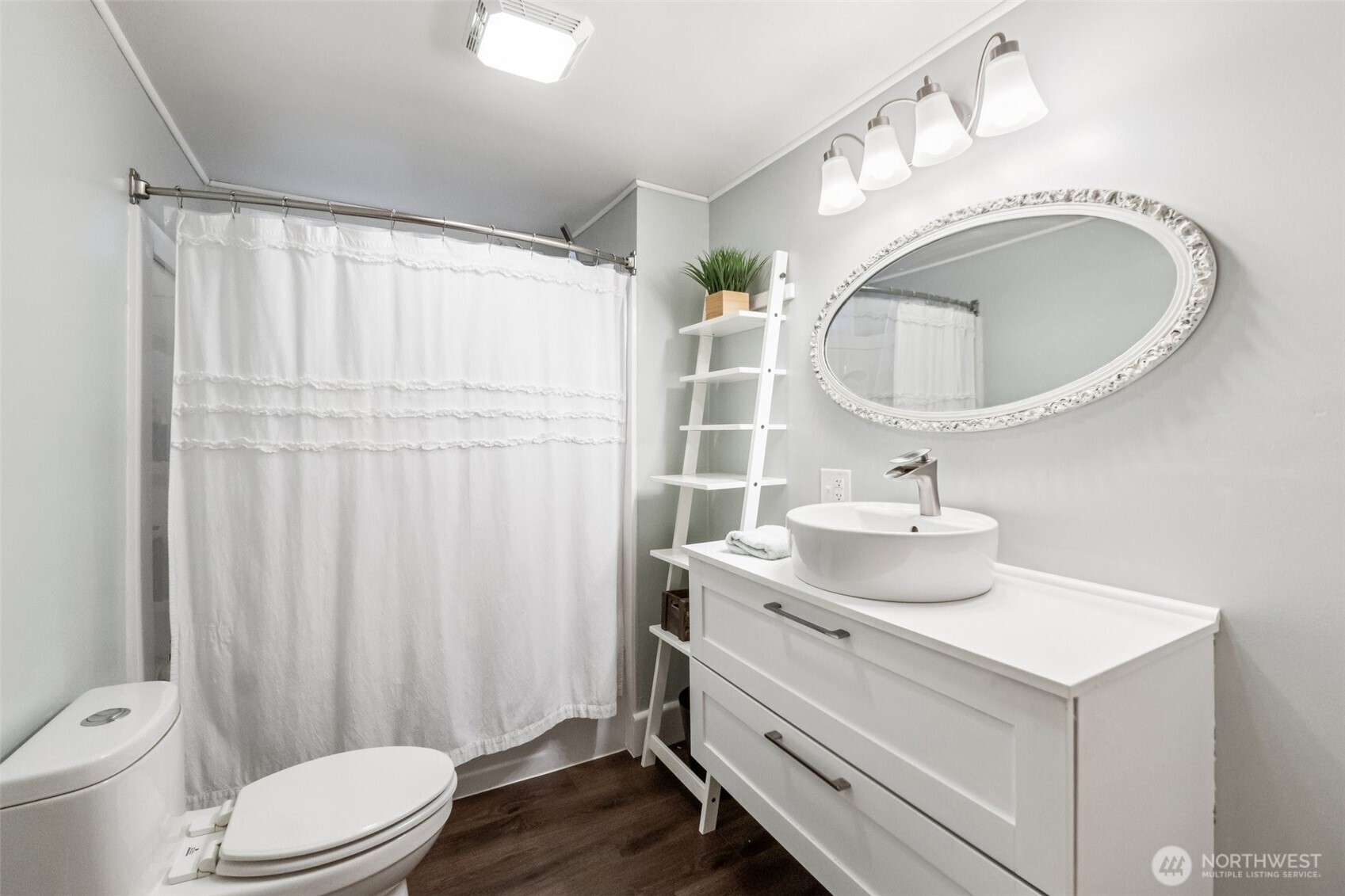 23716 Locust Way Bothell, WA 98021 - Photo 15 of 26 a bathroom with a sink a toilet and a mirror