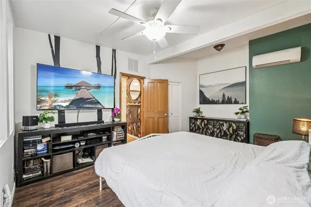 a bedroom with a bed and wooden floor