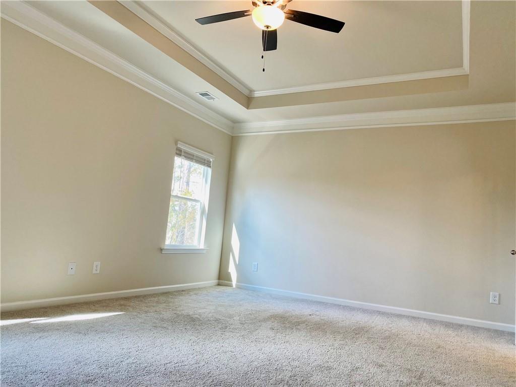 5101 Woodline View Circle Auburn, GA 30011 - Photo 13 of 26 an empty room with a chandelier fan and windows