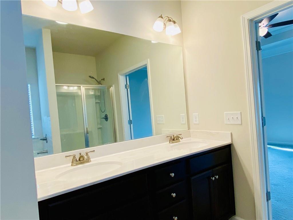 5101 Woodline View Circle Auburn, GA 30011 - Photo 15 of 26 a bathroom with a double vanity sink and a mirror