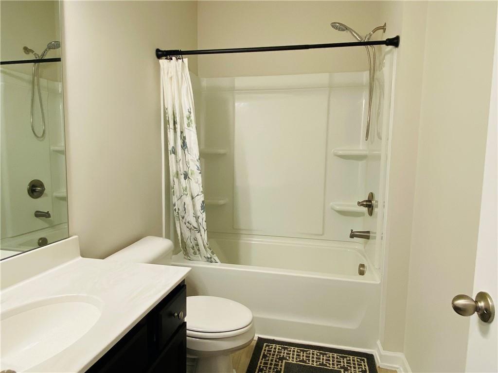 5101 Woodline View Circle Auburn, GA 30011 - Photo 9 of 26 a bathroom with a sink a toilet and shower
