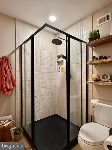a bathroom with a shower toilet and sink