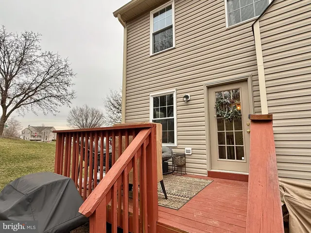 a view of balcony with wooden floor and fence