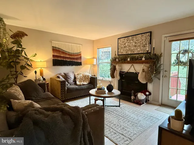 a living room with furniture fireplace and a window