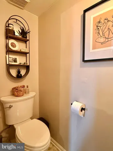a white toilet sitting next to a bathroom sink