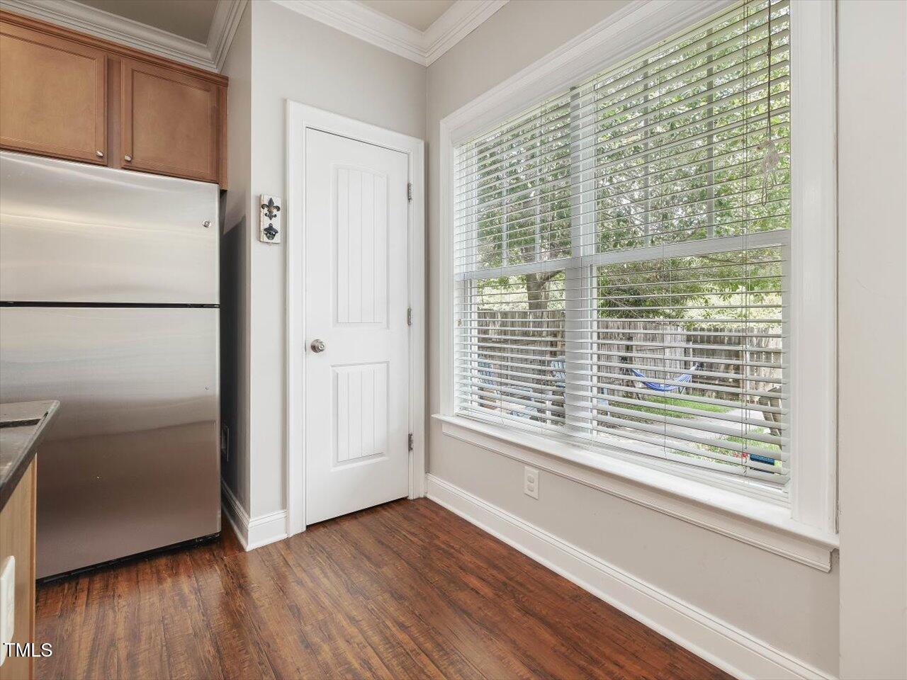 7712 ACC Boulevard Raleigh, NC 27617 - Photo 16 of 38 a view of a kitchen with wooden floor and a refrigerator