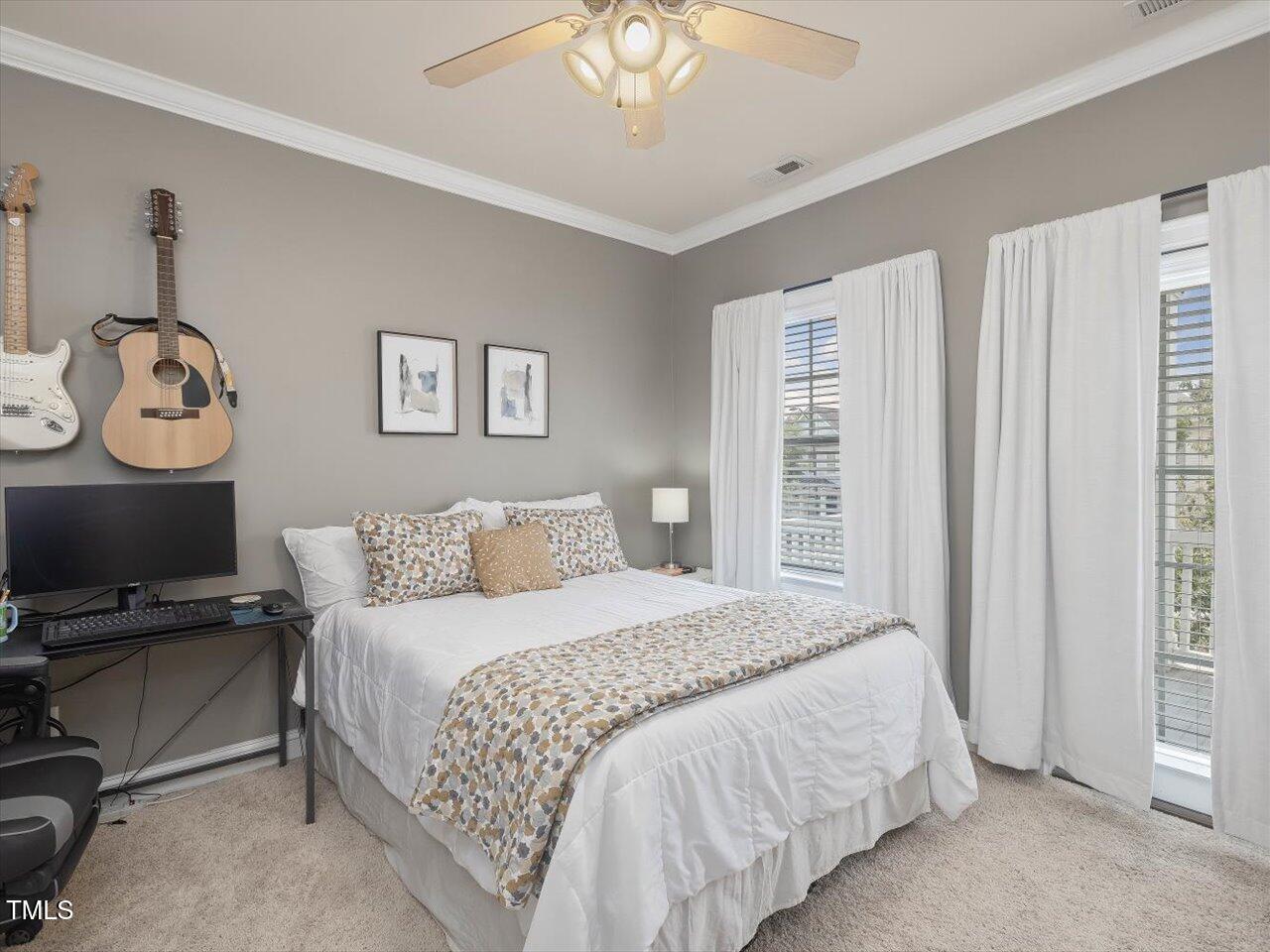 7712 ACC Boulevard Raleigh, NC 27617 - Photo 20 of 38 a bedroom with a bed and a chandelier