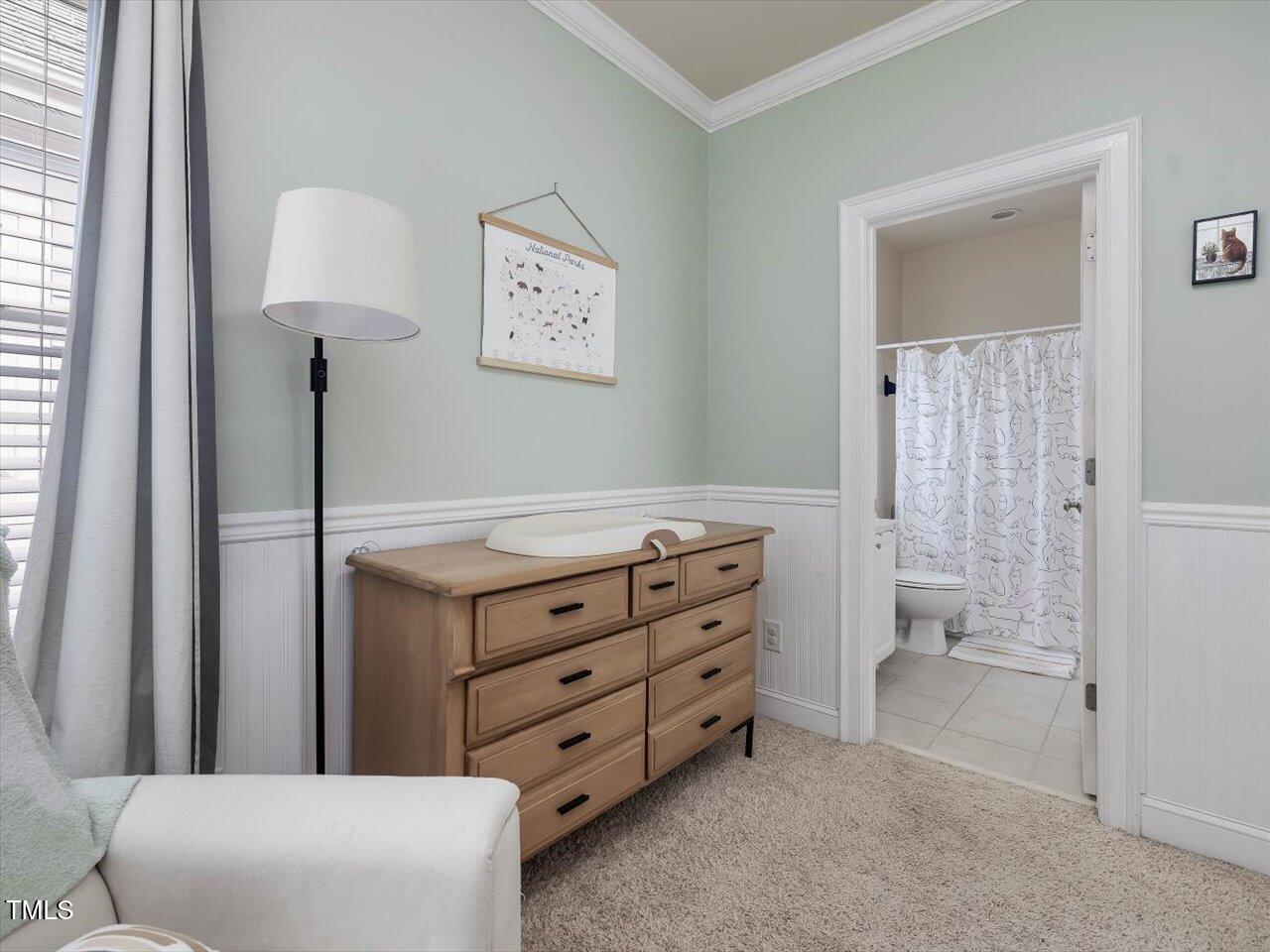 7712 ACC Boulevard Raleigh, NC 27617 - Photo 30 of 38 a room with a dresser and a lamp