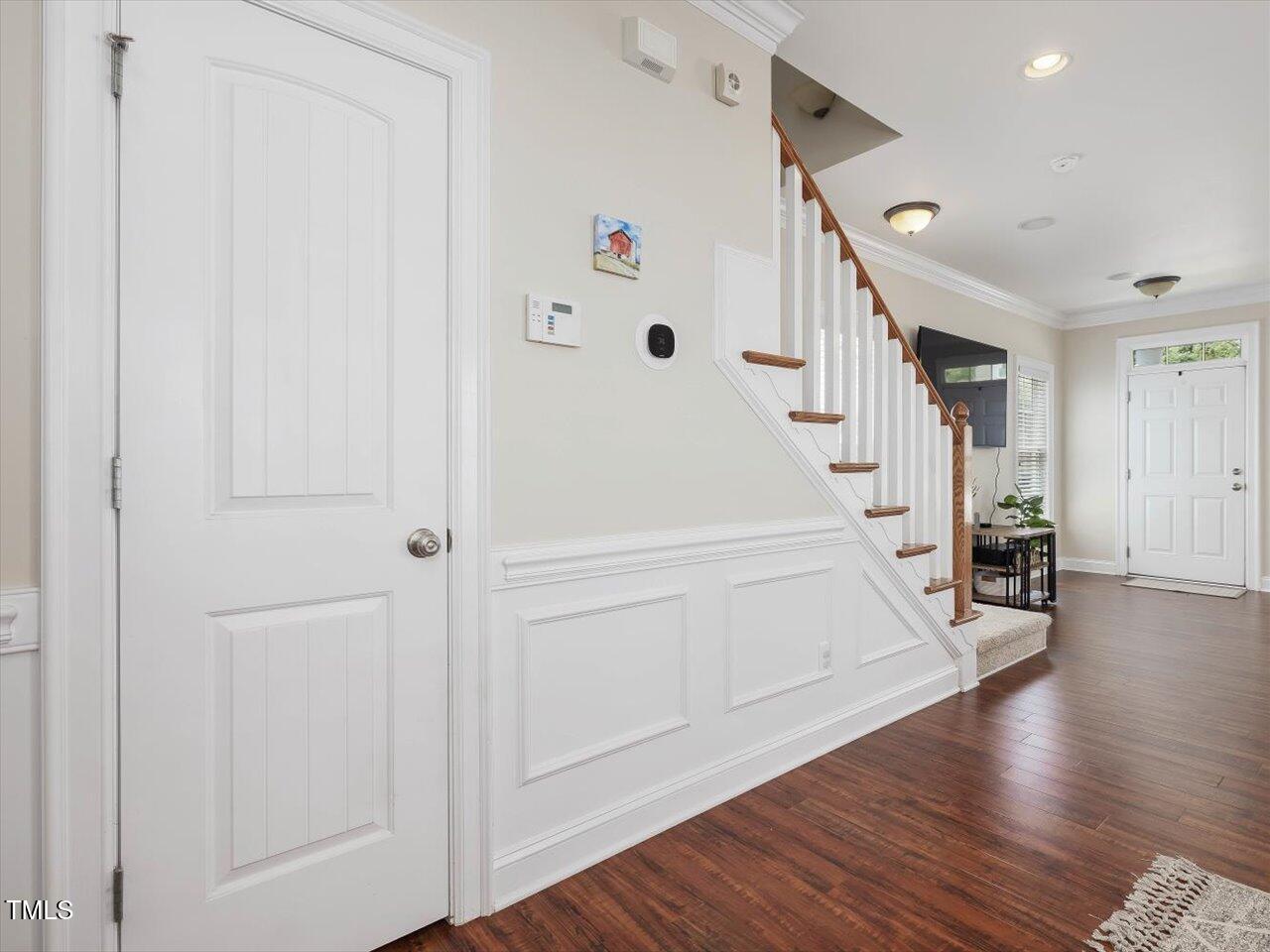 7712 ACC Boulevard Raleigh, NC 27617 - Photo 10 of 38 a view of entryway with stairs and wooden floor