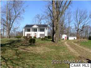 a view of house with a yard