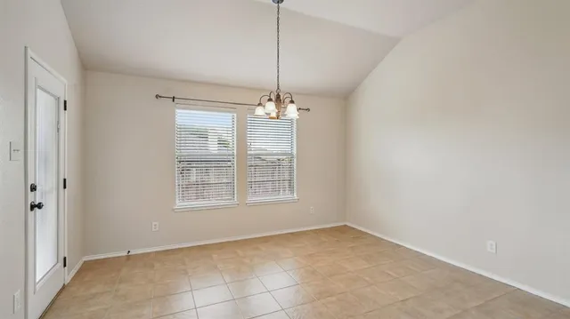 a view of a room with window and chandelier fan