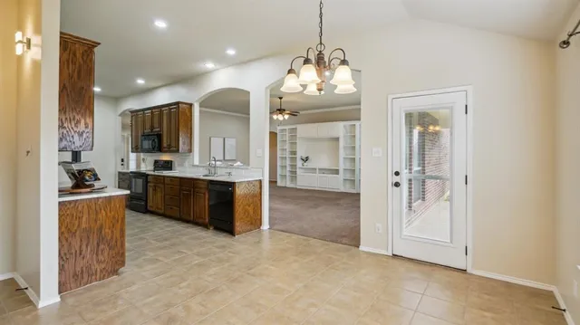 a view of a kitchen with refrigerator and cabinets