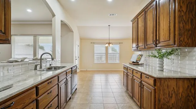 a kitchen with stainless steel appliances granite countertop a sink stove and cabinets